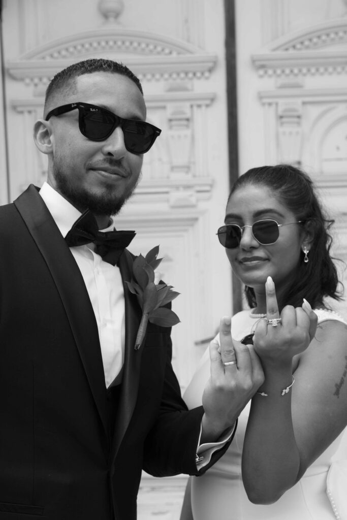 Black and white photo of newlyweds showing their wedding rings